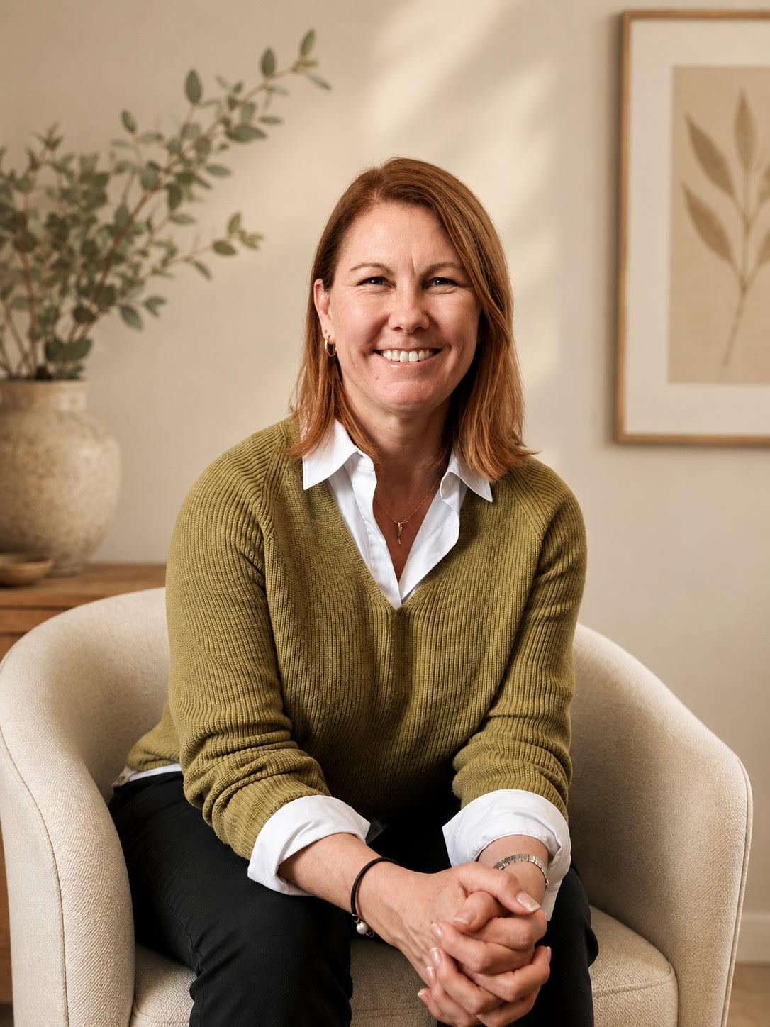 Kristin Tovey, seated and smiling in her counselling room